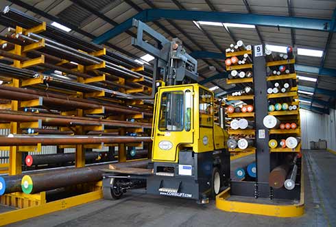 combilift c-serie moving metal billet in guided aisle